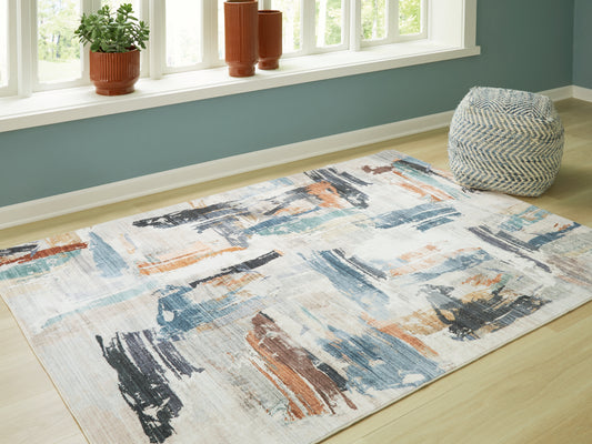 Stuart Furniture Outlet - Ashley Furniture - Hessland Rug - 5' x 7' Washable Rug / Multi - R407052