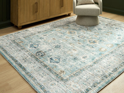 Stuart Furniture Outlet - Ashley Furniture - Ladstoney Rug - 7'6" x 9'6" Area Rug / Teal/Beige/Ochre - R407501