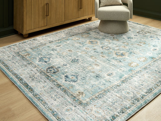 Stuart Furniture Outlet - Ashley Furniture - Ladstoney Rug - 7'6" x 9'6" Area Rug / Teal/Beige/Ochre - R407501